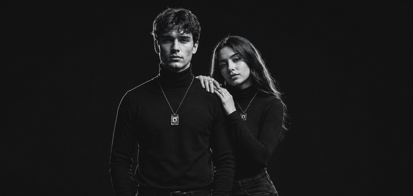 Two people in black turtlenecks, each wearing Ice on its chain